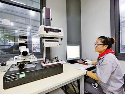 Technician measuring a precision investment cast component for first article approval